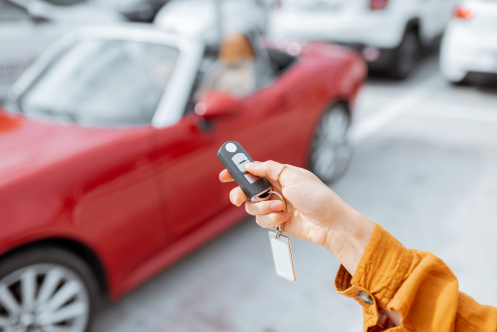 Woman holding keychain at the car parking